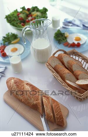 Picture - Sliced bread with egg dishes and salad. Fotosearch