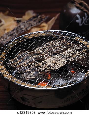 Stock Photo - Slices of dried fish on grill. Fotosearch