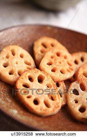 Slices of fried lotus root on plate, close up View Large Photo Image Stock Photo - Slices of fried lotus root on plate, close up. Fotosearch