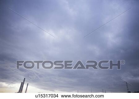 Picture - Smokestacks under a Cloudy Sky. Kurihama, Kanagawa Prefecture, Japan. Fotosearch
