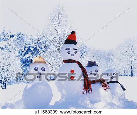 Stock Photo - Snowman family in front of winter trees. Fotosearch