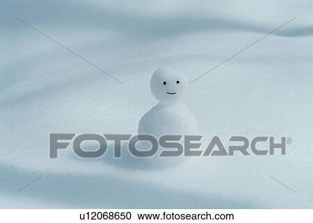 Stock Image - Snowman on snowy land, white background. Fotosearch