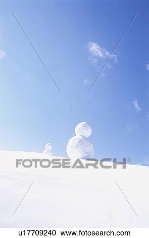 Snowmen Under a Blue Sky View Large Photo Image Stock Image - Snowmen Under a Blue Sky. Fotosearch