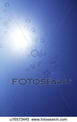 Soap bubbles in sky, blue background View Large Photo Image Stock Photography - Soap bubbles in sky, blue background. Fotosearch