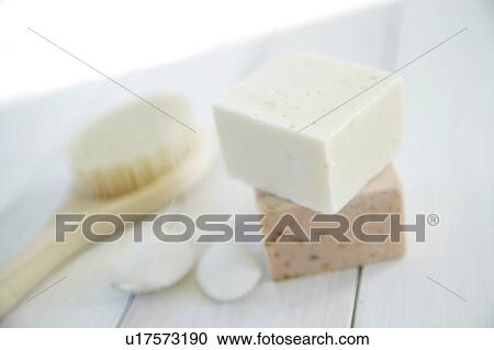 Stock Image - Soaps and brush on floor, close up. Fotosearch