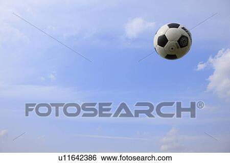 Stock Photograph - Soccer ball in mid-air. Fotosearch