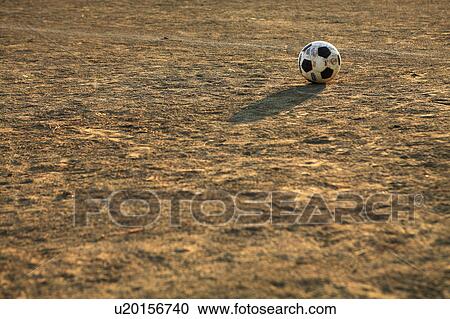 Stock Image - Soccer ball on ground. Fotosearch