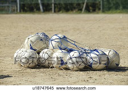 Stock Photography - Soccer balls in net. Fotosearch