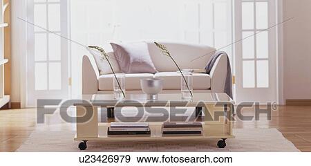 Stock Photo - Sofa and coffee table with vases. Fotosearch