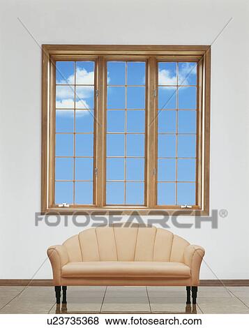 Stock Photo - Sofa beside window with blue sky. Fotosearch