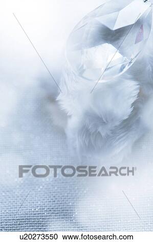 Stock Image - Soft white feathers and a crystal. Fotosearch
