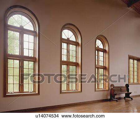 Picture - Spacious room with arched windows and pew. Fotosearch
