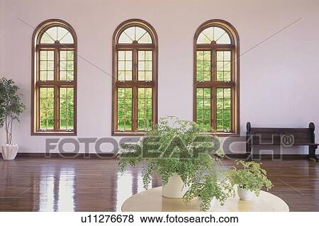 Stock Photo - Spacious room with pot plant and pew. Fotosearch