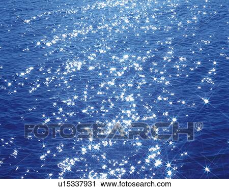 Stock Image - Sparkling sunshine reflecting off water surface. Fotosearch