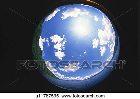 Stock Photography - Sphere reflecting tree covered hills, blue sky and clouds. Fotosearch