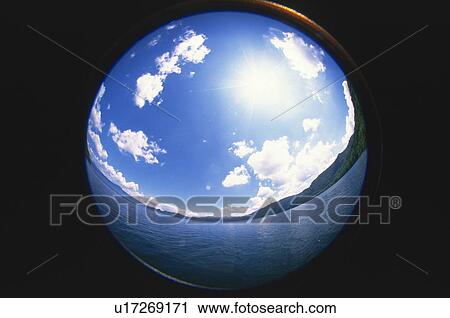 Stock Image - Sphere reflecting water, sun, blue sky and clouds. Fotosearch