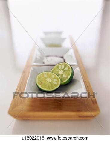 Stock Photograph - Square plates in a row with cut lime. Fotosearch