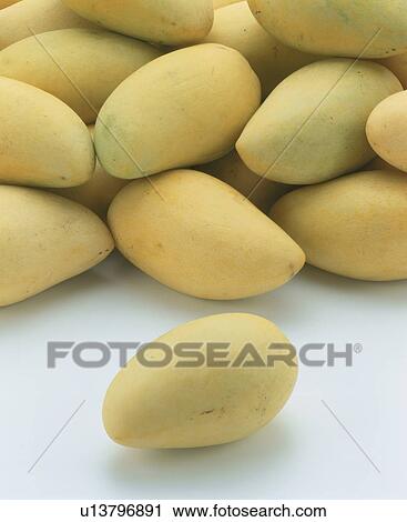 Stock Image - Stack of mangos, white background. Fotosearch