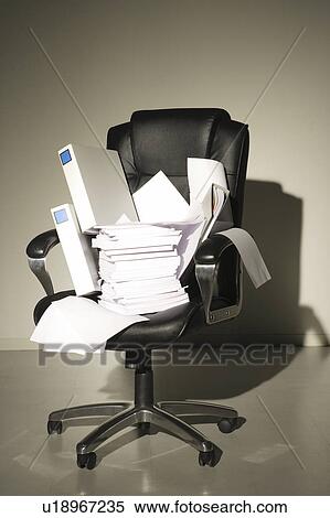 Stock Photography - Stack of papers and files on chair. Fotosearch