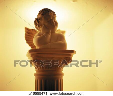 Statue of angel, colored background View Large Photo Image Stock Image - Statue of angel, colored background. Fotosearch