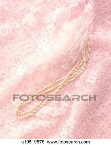Stock Photo - String of pearls on pink lace. Fotosearch