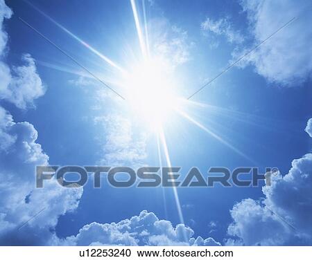 Stock Image - Sun, blue sky and clouds. Fotosearch