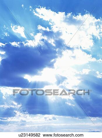 Stock Image - Sun, blue sky and clouds. Fotosearch