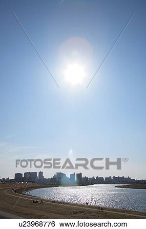 Sun over office buildings and Tama river, Kawasaki city, Kanagawa prefecture, Japan View Large Photo Image Stock Photograph - Sun over office buildings and Tama river, Kawasaki city, Kanagawa prefecture, Japan. Fotosearch