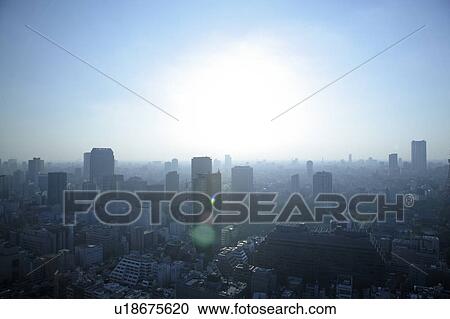 Stock Image - Sunlight over office buildings, Tokyo prefecture, Japan. Fotosearch