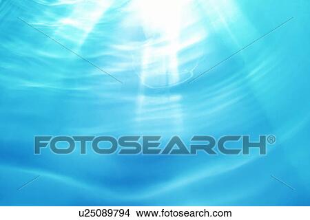 Picture - Sunlight penetrating water surface. Fotosearch