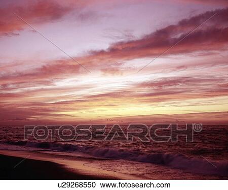 Stock Image - Sunrise Color Over Ocean. Fotosearch