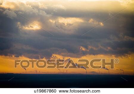 Stock Image - Sunrise over smoke stacks emitting smoke, Atago-yama, Kasama, Ibaraki Prefecture, Japan. Fotosearch