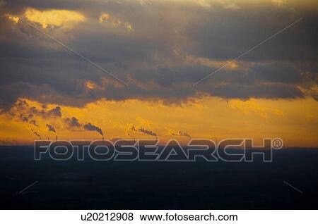 Stock Photo - Sunrise over smoke stacks emitting smoke, Atago-yama, Kasama, Ibaraki Prefecture, Japan. Fotosearch