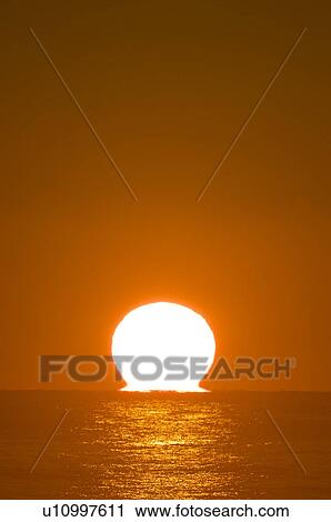 Stock Image - Sunrise Over the Horizon. Fotosearch