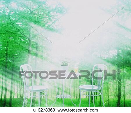Stock Photo - Table and chairs in a forest. Fotosearch