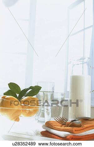 Stock Photo - Table with lemon bowl and napkins. Fotosearch