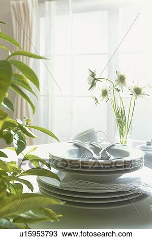 Stock Image - Tableware stacked in the sunlight. Fotosearch