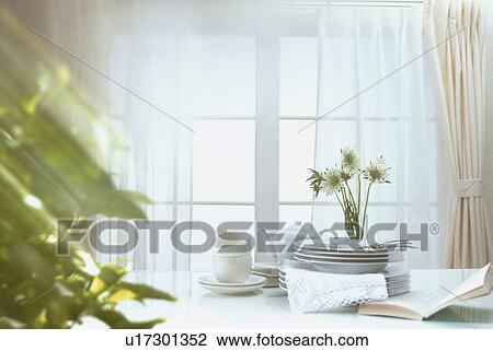 Stock Image - Tableware stacked in the sunlight. Fotosearch