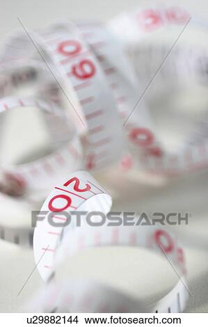 Picture - Tape measure, close up, white background. Fotosearch