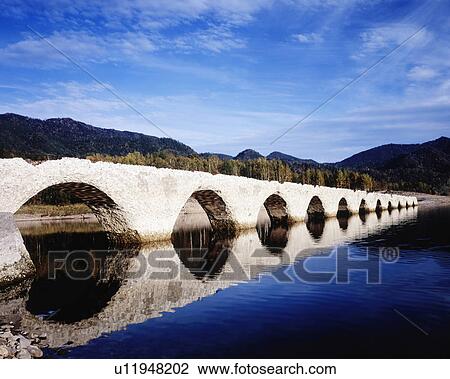 Stock Image - Taushubetsu bridge in Lake Tobira, Hokkaido prefecture, Japan. Fotosearch