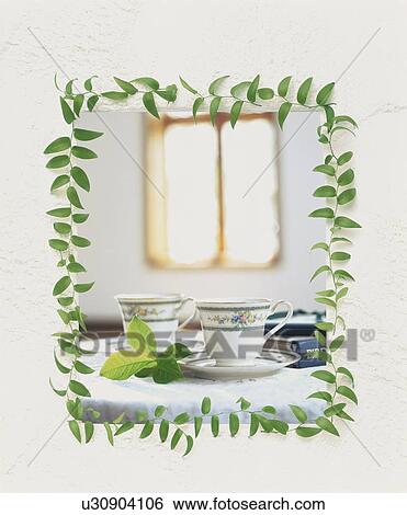 Stock Photograph - Tea cups with white border and vine leaves. Fotosearch