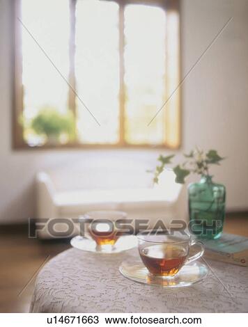 Stock Image - Tea for two on a table with books. Fotosearch