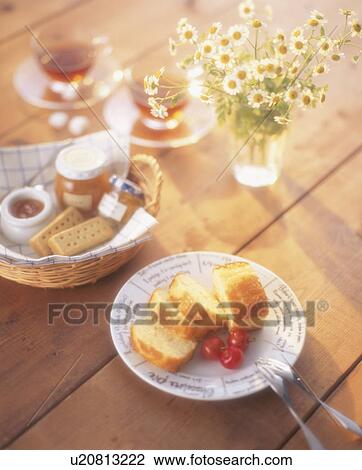 Stock Image - Tea for two with cake and biscuits. Fotosearch