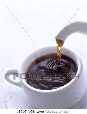 Stock Photo - Tea pouring from teapot into mug. Fotosearch