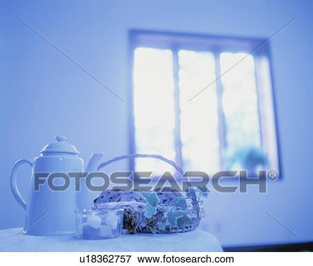 Stock Photo - Teapot and bread on table near window. Fotosearch