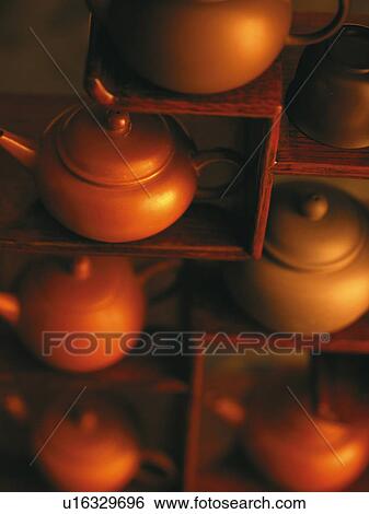Stock Photograph - Teapots on wooden shelves. Fotosearch