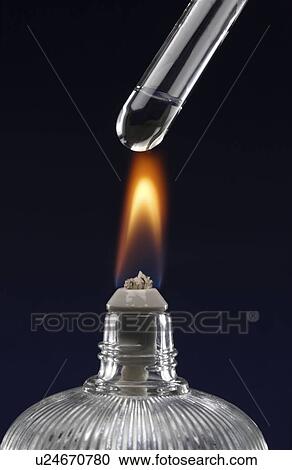 Stock Image - Test tube with liquid, over flame. Fotosearch