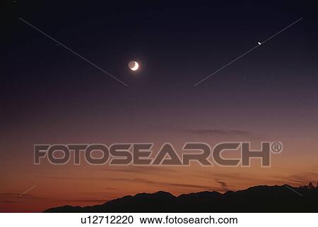 Stock Image - The Sky and a Mountain Range at Dawn. Fotosearch