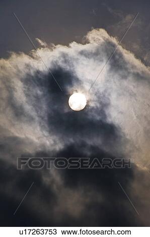 The Sun Appearing Behind Dark Clouds View Large Photo Image Stock Image - The Sun Appearing Behind Dark Clouds. Fotosearch