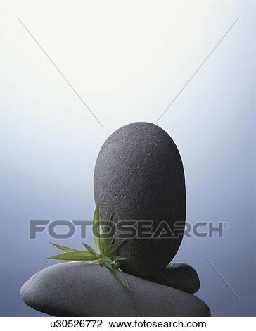 Stock Image - Three stones and some grass. Fotosearch